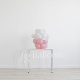 Decorative balloon display on a stand against a white wall with 'fig balloons' branding.
