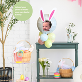 Easter-themed room with bunny ears, eggs, and a baby in a photo frame.